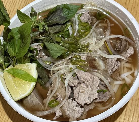 Special pho with sliced beef, Thai basil, bean sprouts and lime